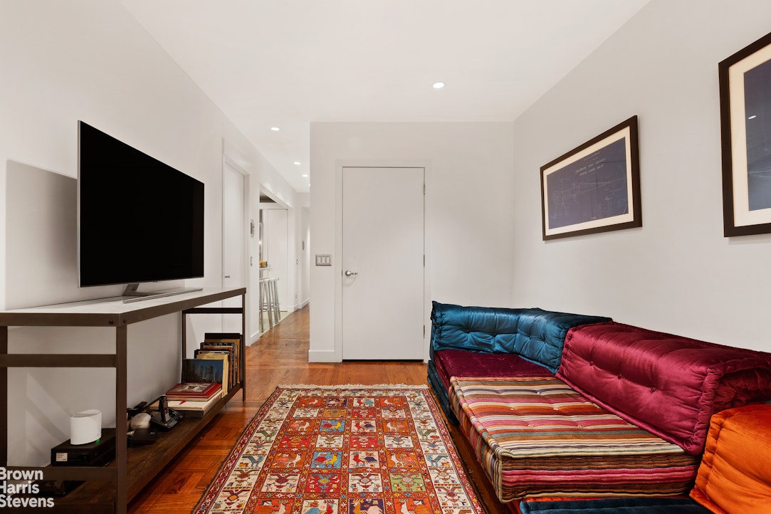 135 East 39th Street, Unit 1CD Manhattan, NY 10016 - Photo 5 of 11 a living room with furniture and a flat screen tv