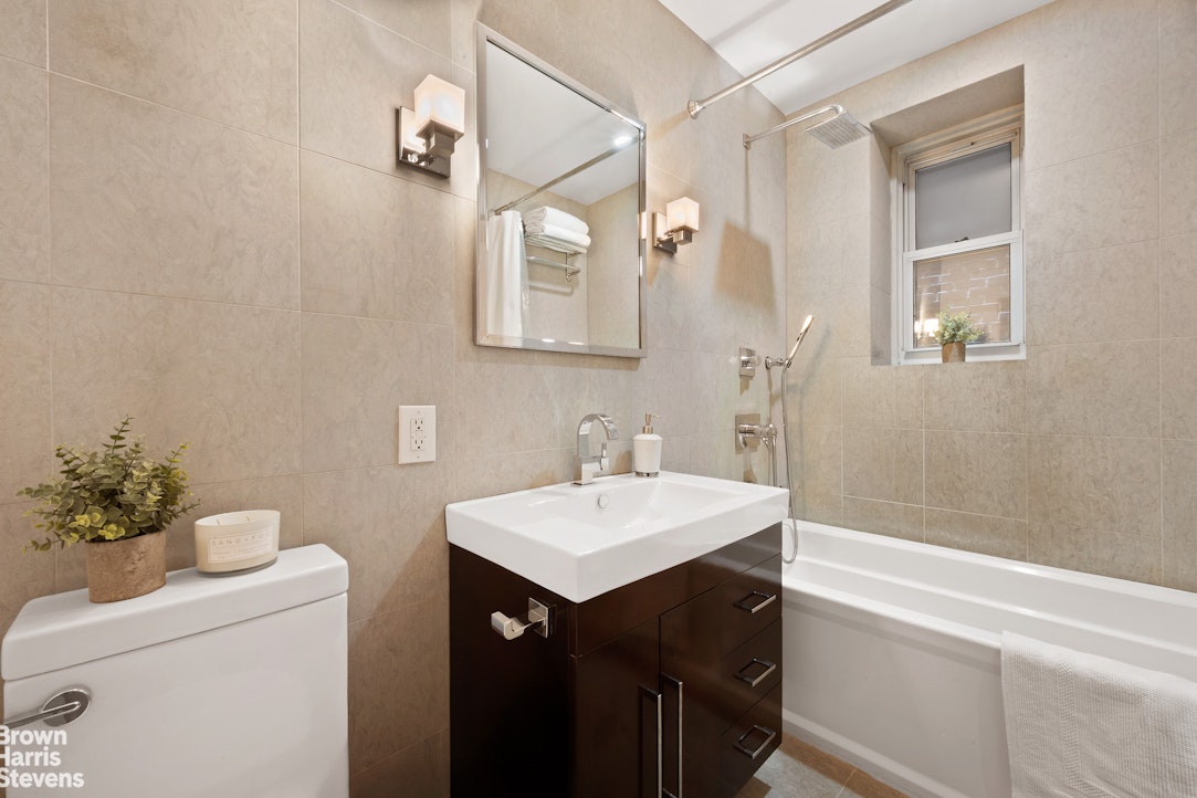 135 East 39th Street, Unit 1CD Manhattan, NY 10016 - Photo 7 of 11 a bathroom with a sink vanity and a mirror
