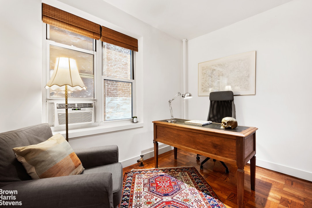 135 East 39th Street, Unit 1CD Manhattan, NY 10016 - Photo 8 of 11 a living room with furniture and a window