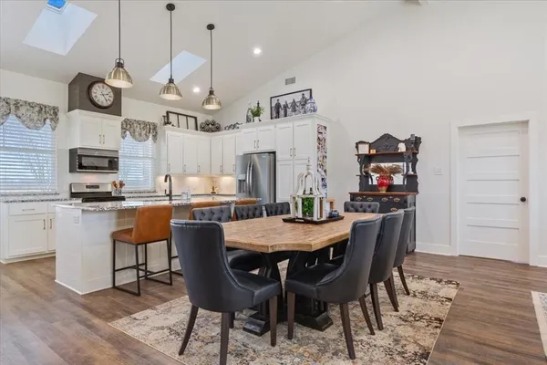 a view of a dining room with furniture and wooden floor