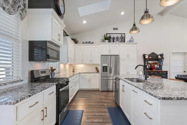 a kitchen with a sink stove and refrigerator