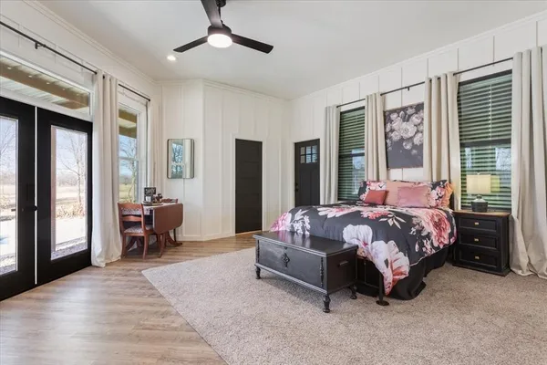 a bedroom with a bed mirror and window