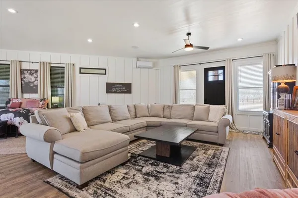 a living room with furniture and wooden floor