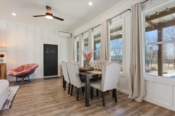 a view of a dining room with furniture window and wooden floor