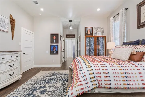 a bedroom with a bed and painting on the wall