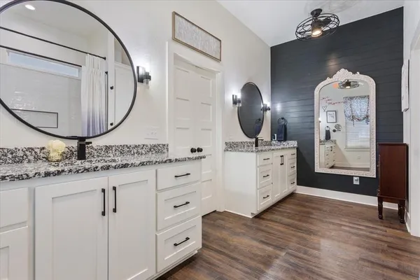 a bathroom with a double vanity sink and a mirror