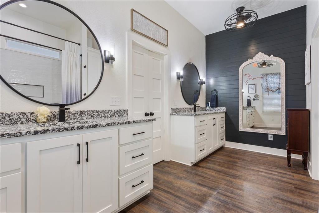 1652 Mt Moriah Road Riesel, TX 76682 - Photo 22 of 40 a bathroom with a double vanity sink and a mirror