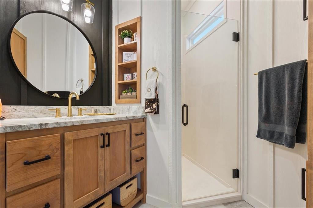 1652 Mt Moriah Road Riesel, TX 76682 - Photo 26 of 40 a bathroom with a sink a mirror a vanity and a shower