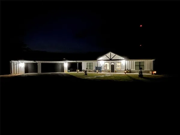 a front view of a house with a big yard