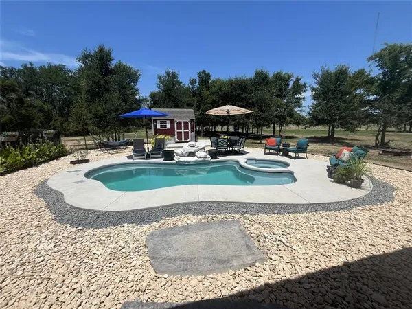 a view of a house with backyard porch and sitting area