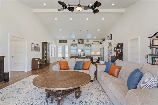 a living room with furniture and kitchen view