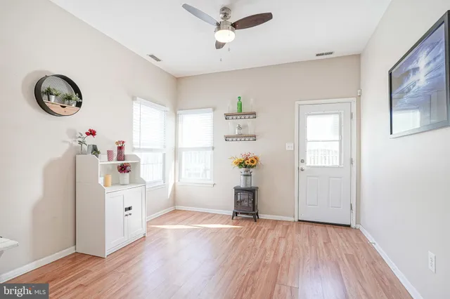 a view of empty room with wooden floor and window