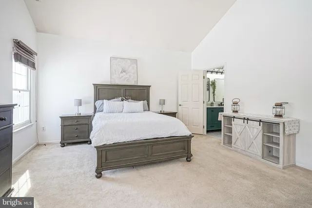 a spacious bedroom with a bed and a cabinets