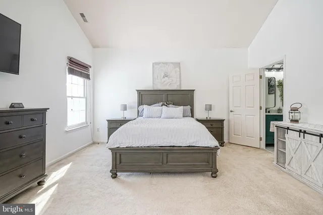 a spacious bedroom with a bed and furniture