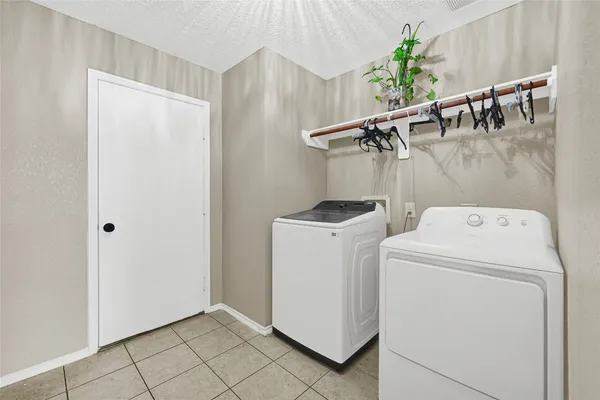 a view of storage and utility room with washer and dryer