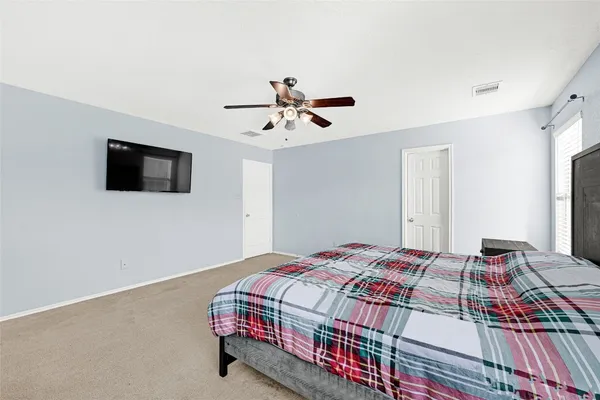 a bedroom with a bed and a flat screen tv