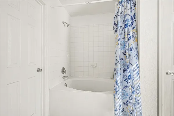 a bathroom with a bathtub and shower curtain