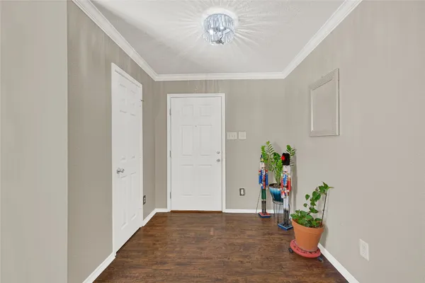 a view of an entryway with wooden floor