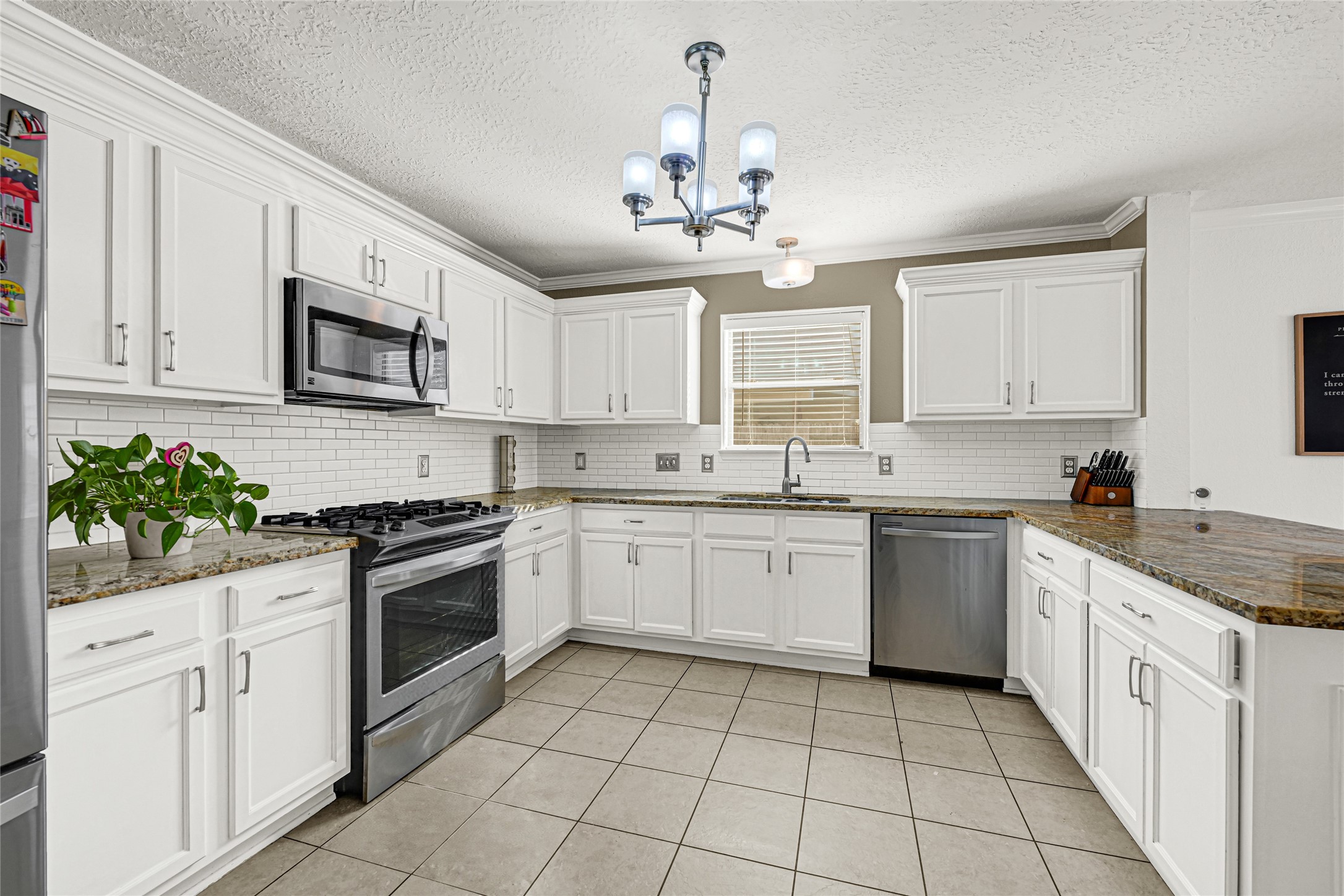 2911 Aspen Fair Trail Spring, TX 77389 - Photo 9 of 24 a kitchen with a stove top oven sink and cabinets