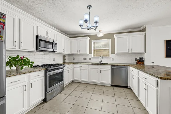 a kitchen with a stove top oven sink and cabinets