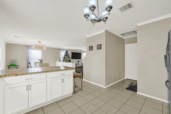 a spacious bathroom with a granite countertop sink a toilet and mirror