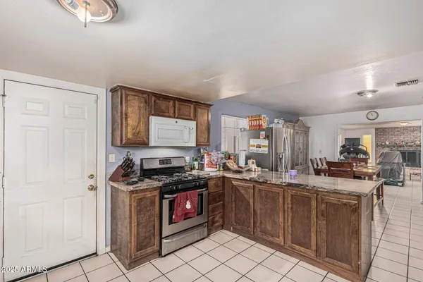 a kitchen with a refrigerator and a window