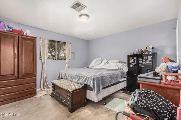 a bed room with a bed and a dresser