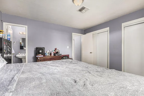 a bathroom with a sink a toilet and shower curtain