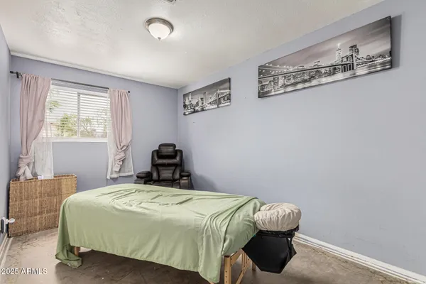 a bedroom with a bed and a mirror