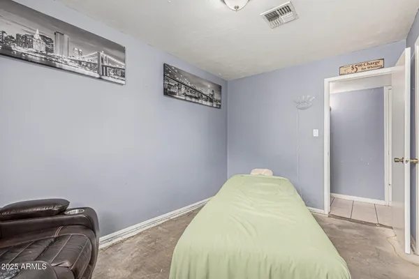 a bedroom with a bed and dresser with mirror