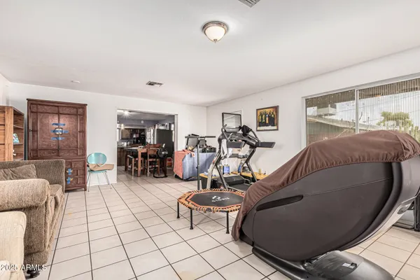 a bedroom with furniture and a flat screen tv