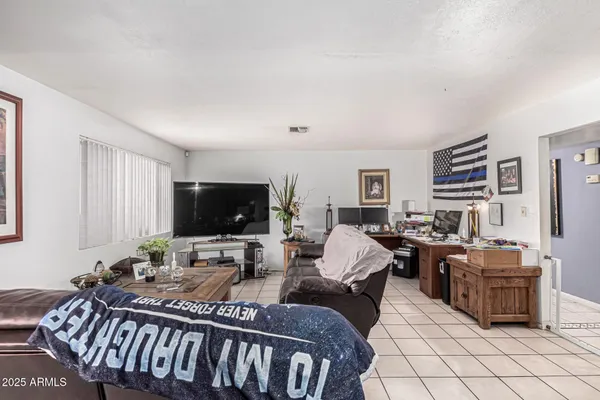 a large bedroom with a bed and a large window