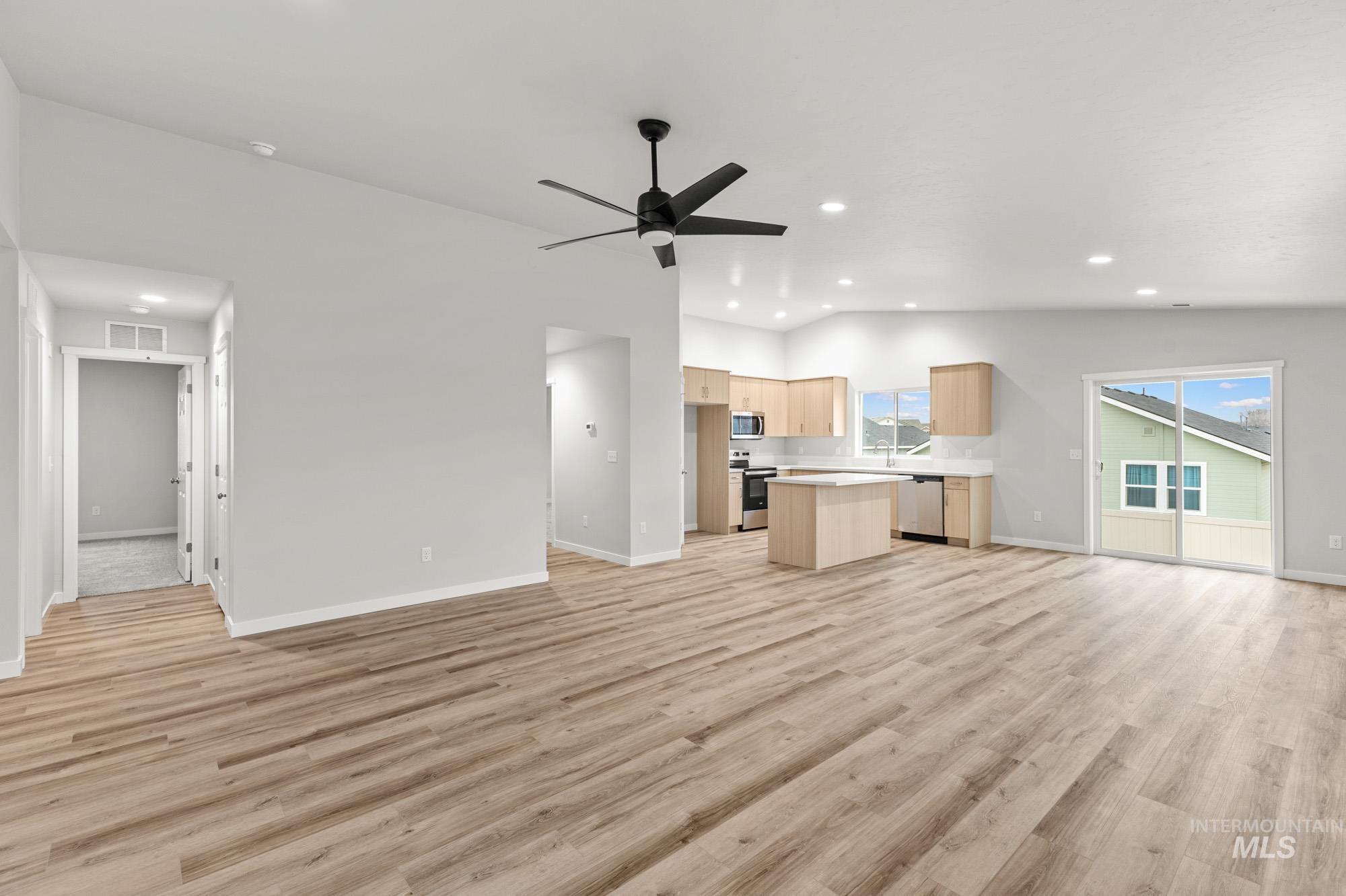 13307 Bank Street Caldwell, ID 83607 - Photo 8 of 20 Vaulted ceilings and wood-finish flooring complement the open-concept living area