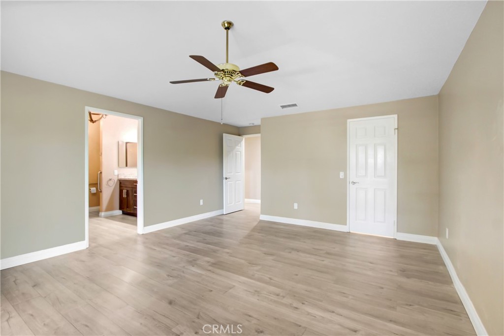 2166 Malati Circle Upland, CA 91784 - Photo 19 of 40 a view of an empty room with window and wooden floor