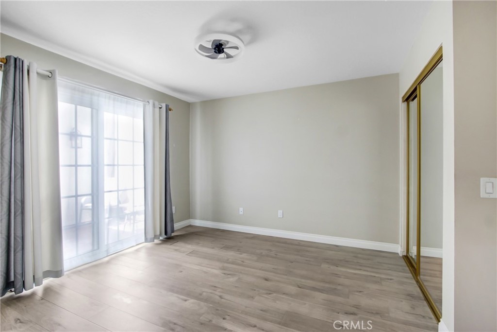 2166 Malati Circle Upland, CA 91784 - Photo 22 of 40 a view of an empty room with wooden floor and a window