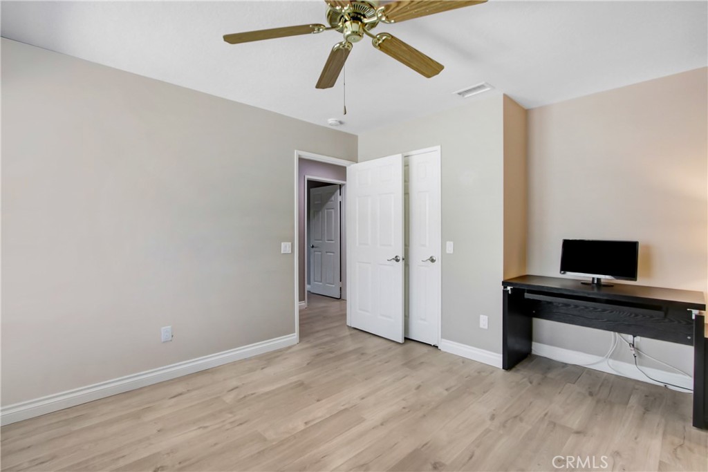 2166 Malati Circle Upland, CA 91784 - Photo 26 of 40 a view of a workspace with wooden floor and a ceiling fan