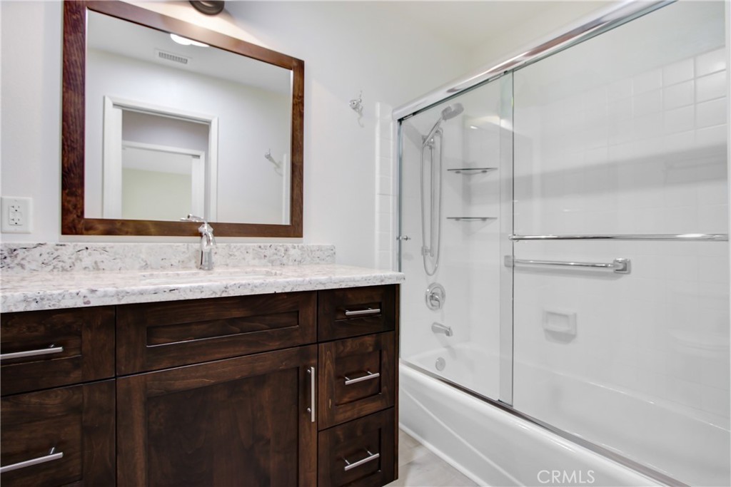 2166 Malati Circle Upland, CA 91784 - Photo 28 of 40 a bathroom with a shower sink and mirror