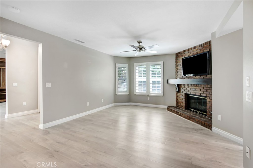 2166 Malati Circle Upland, CA 91784 - Photo 9 of 40 a view of an empty room with a fireplace and a window