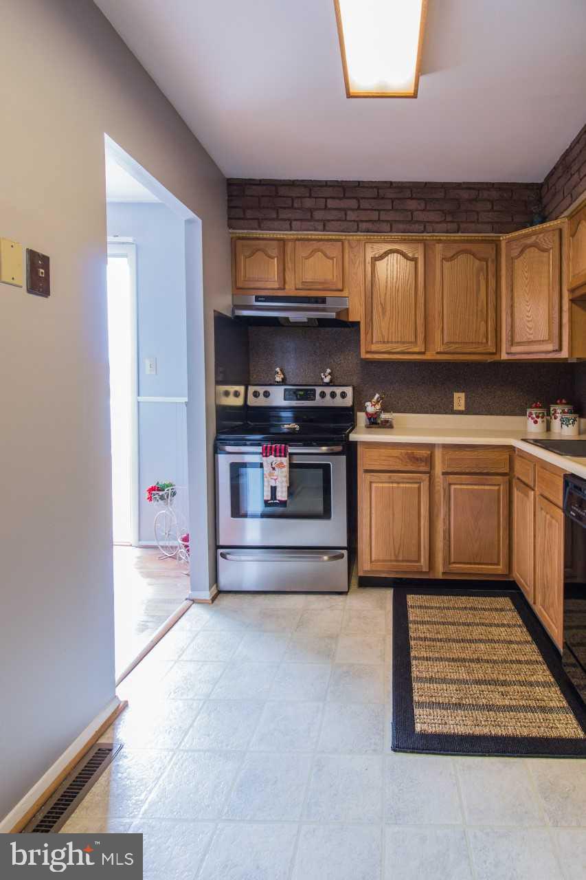 3941 Bayville Road Baltimore, MD 21220 - Photo 12 of 32 a kitchen with wooden cabinets and a stove top oven