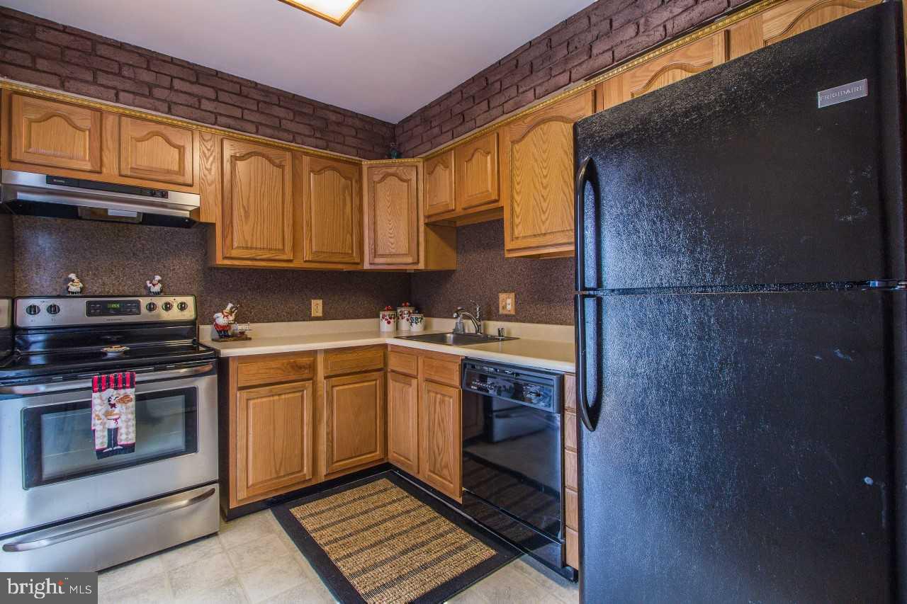 3941 Bayville Road Baltimore, MD 21220 - Photo 13 of 32 a kitchen with stainless steel appliances granite countertop a stove a sink and a microwave