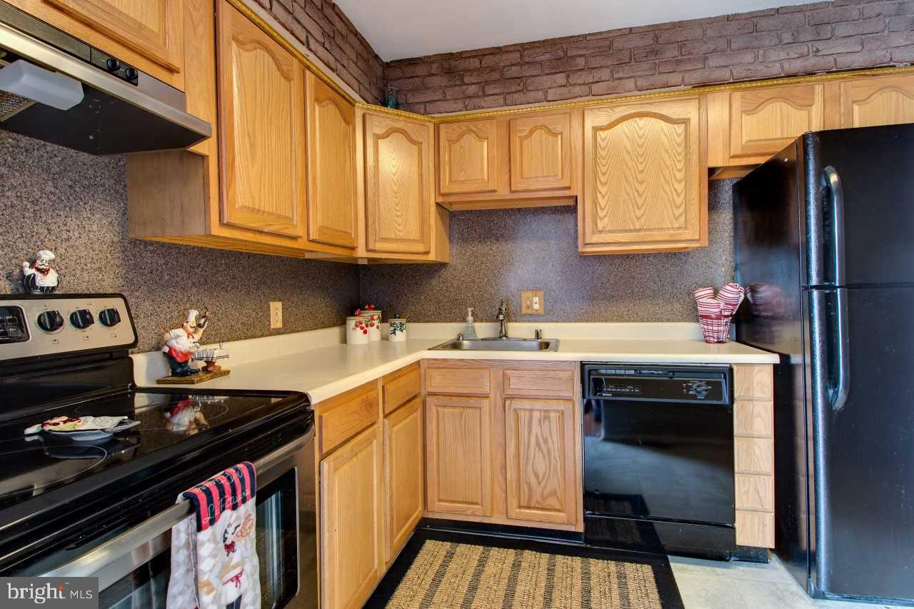 3941 Bayville Road Baltimore, MD 21220 - Photo 14 of 32 a kitchen with stainless steel appliances granite countertop a stove and a refrigerator