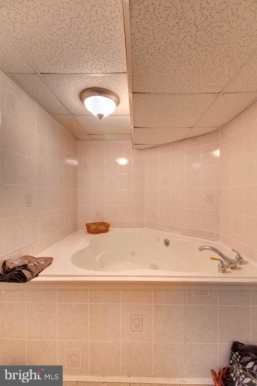 3941 Bayville Road Baltimore, MD 21220 - Photo 28 of 32 a bathroom with a bathtub and shower