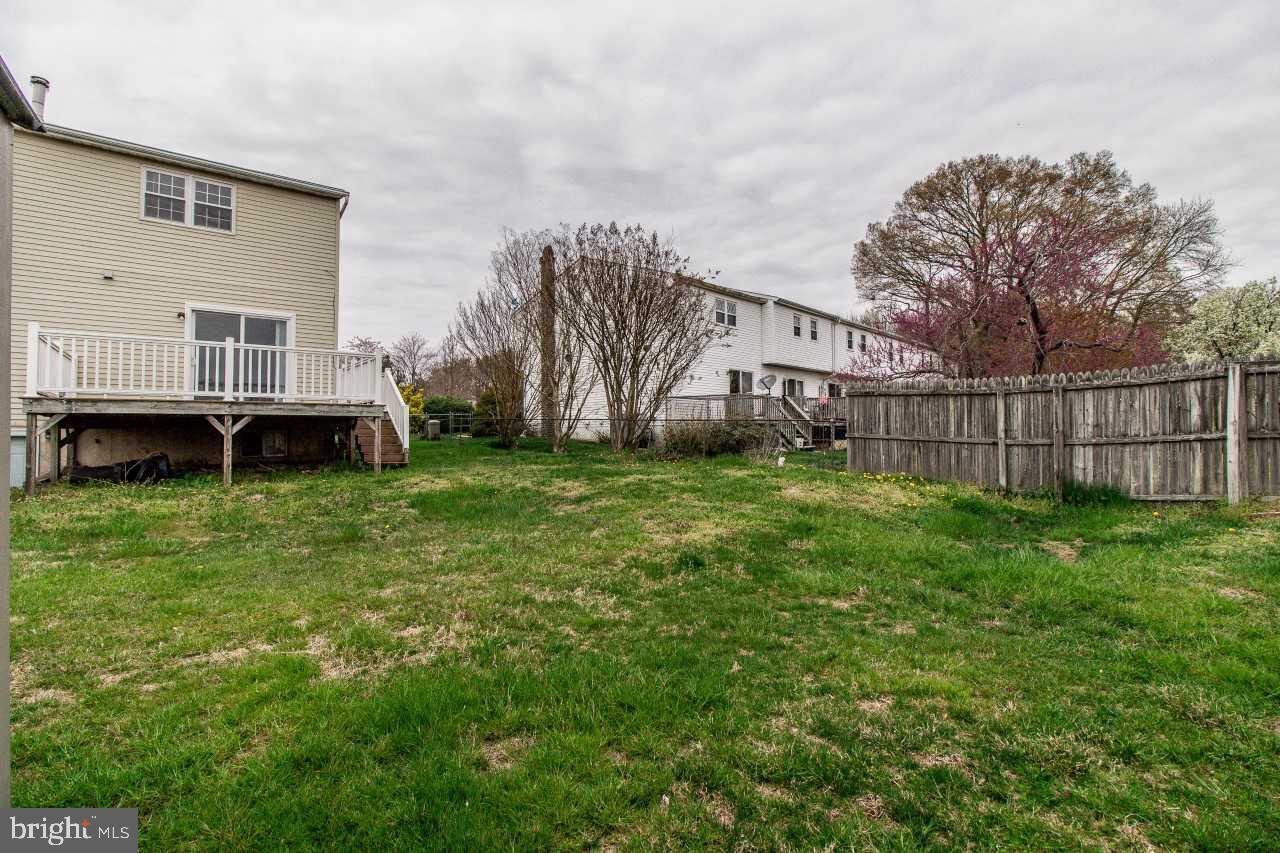 3941 Bayville Road Baltimore, MD 21220 - Photo 31 of 32 a view of a house with a big yard and a large tree