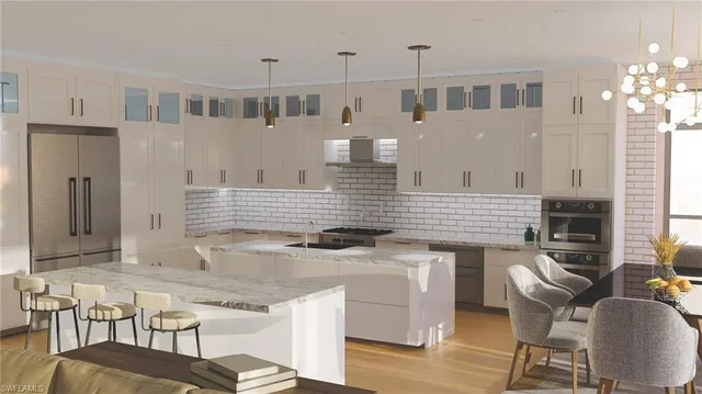 a kitchen with stainless steel appliances granite countertop a stove top oven a dining table and chairs with wooden floor