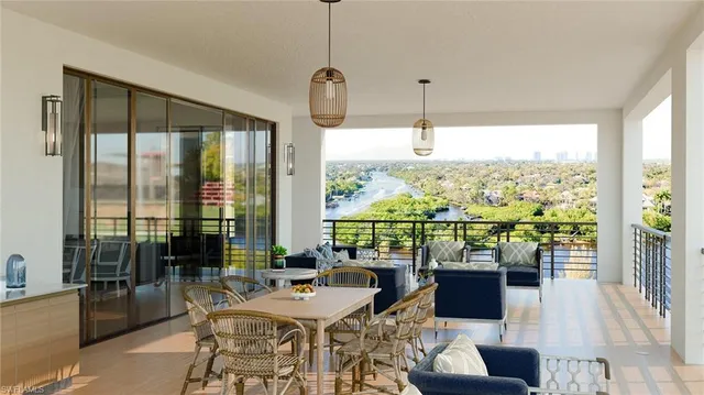 a very nice looking living room with a large window and dining table
