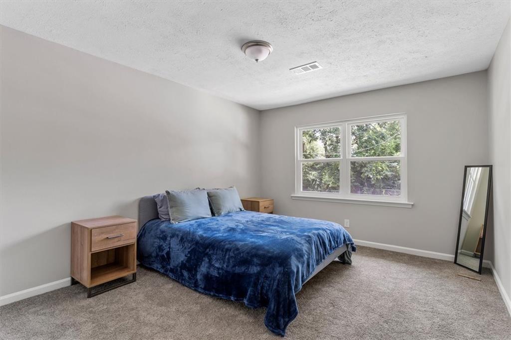 1701 Hawthorne Avenue, Unit 9 Atlanta, GA 30337 - Photo 11 of 16 a spacious bedroom with a bed and a window