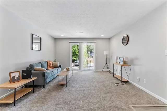 a living room with furniture a window and a table