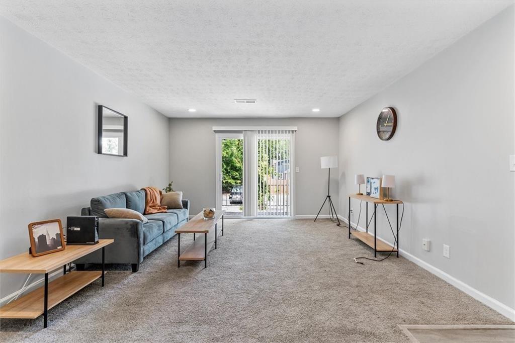 1701 Hawthorne Avenue, Unit 9 Atlanta, GA 30337 - Photo 3 of 16 a living room with furniture a window and a table