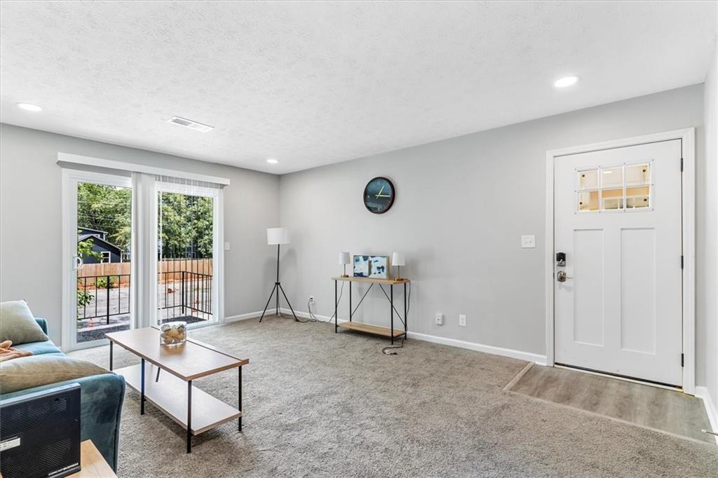 1701 Hawthorne Avenue, Unit 9 Atlanta, GA 30337 - Photo 4 of 16 a living room with furniture and a window