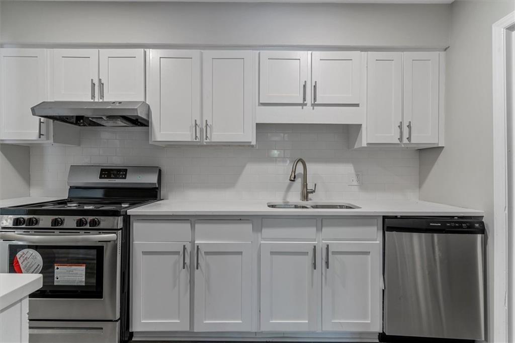 1701 Hawthorne Avenue, Unit 9 Atlanta, GA 30337 - Photo 7 of 16 a kitchen with white cabinets and appliances